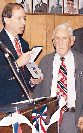 World War II veteran Frank Mora, right, receives one of two Purple Hearts from U.S. Rep. Tom Udall.